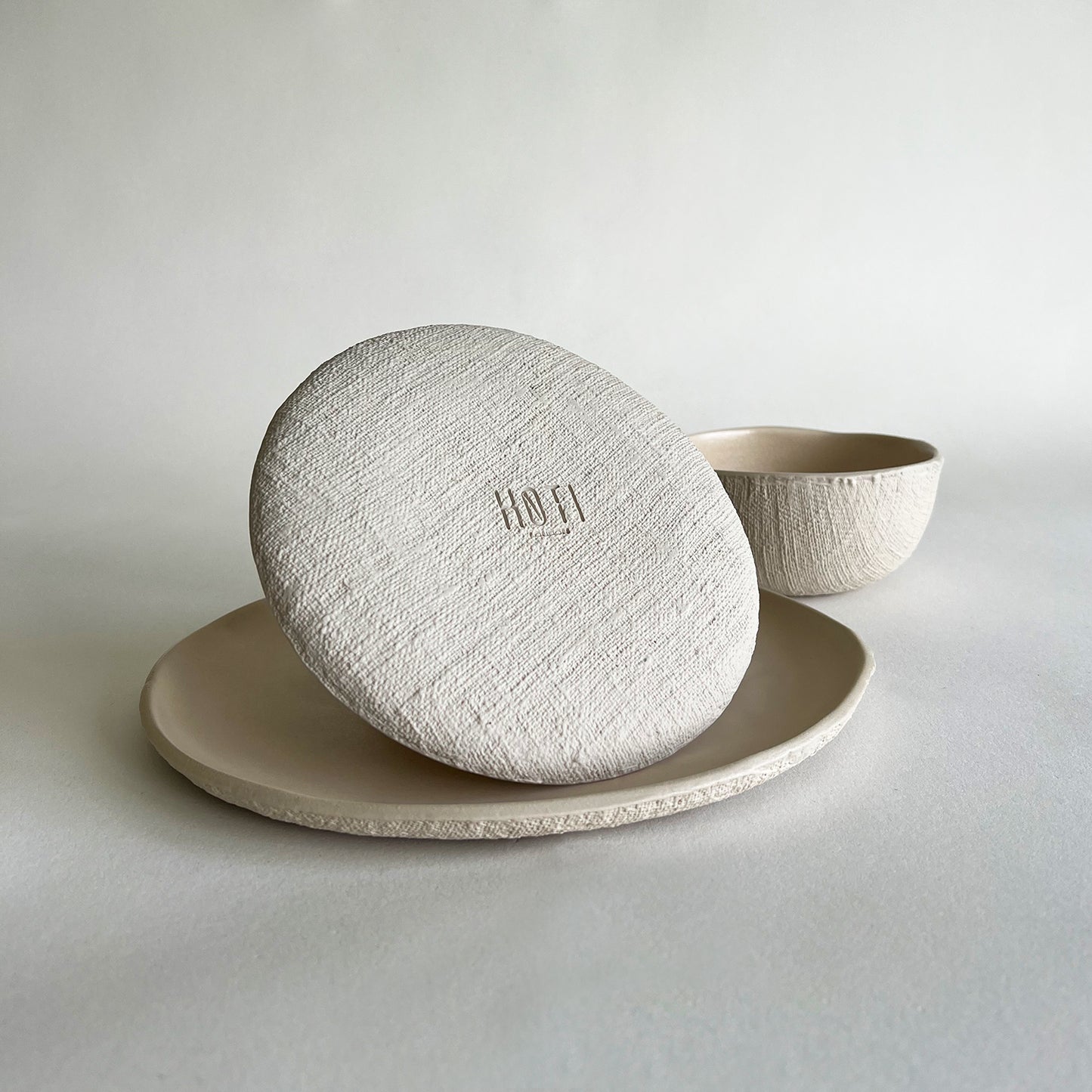 beige handmade ceramic dinnerware set of large plate, small plate, bowl