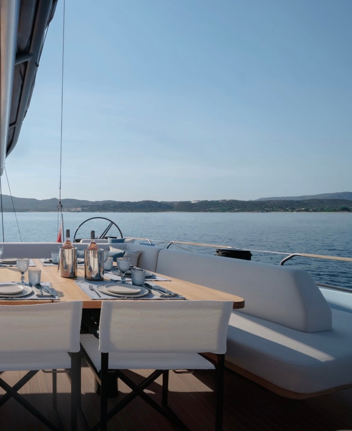 setting up table on the yacht with beige ceramic dinnerware set