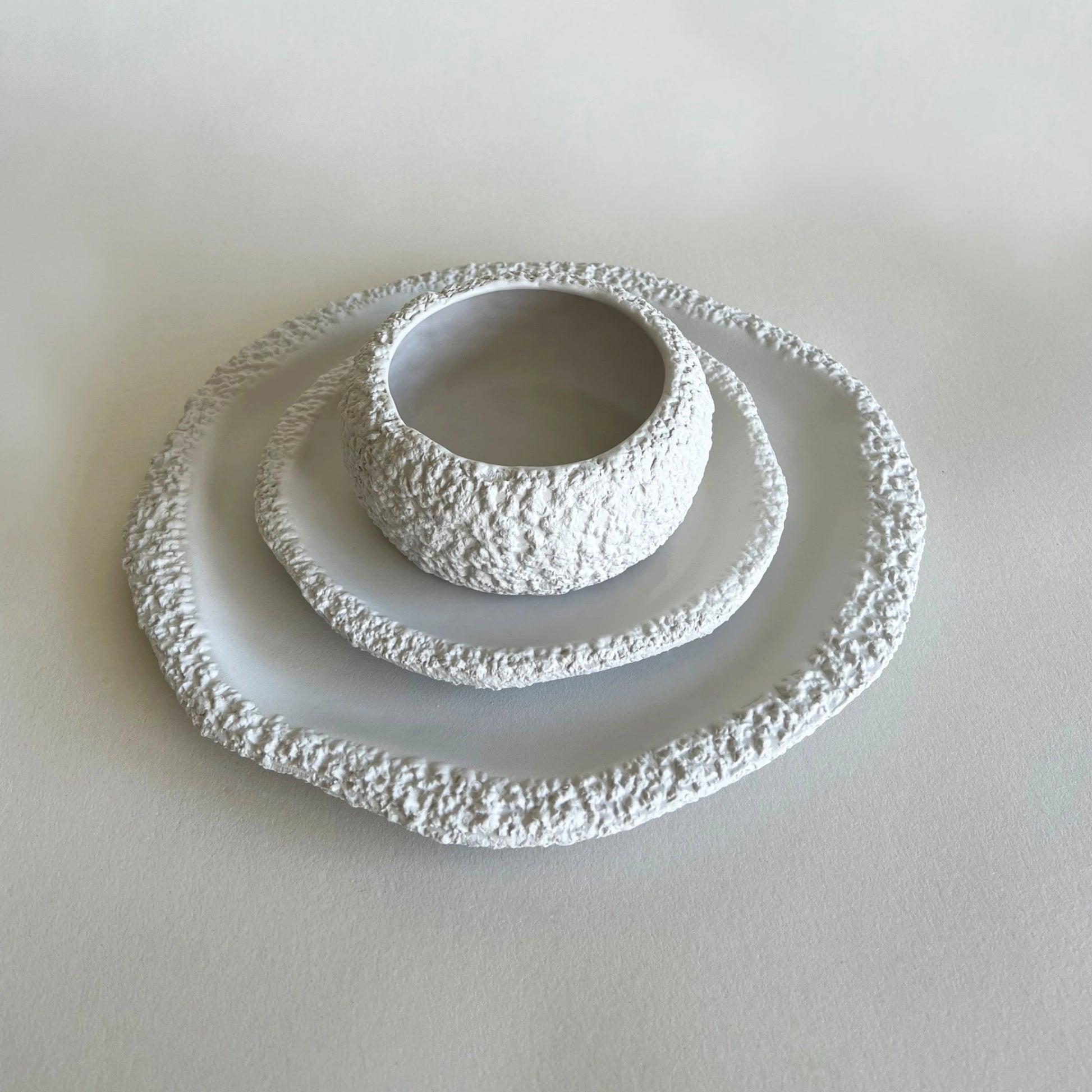 large and dessert raw textured white ceramic plates with matching soup bowl 