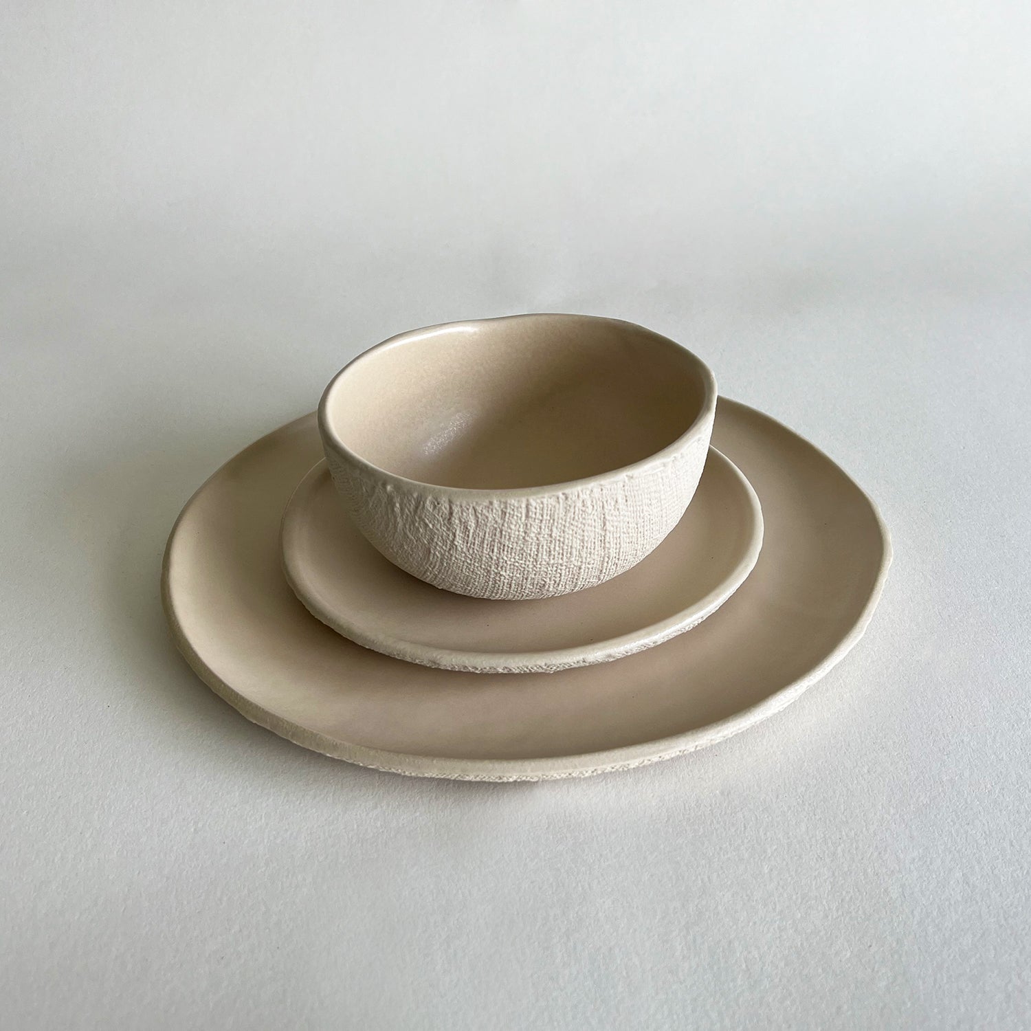 beige natural ceramic dinnerware set of large plate, small plate and bowl