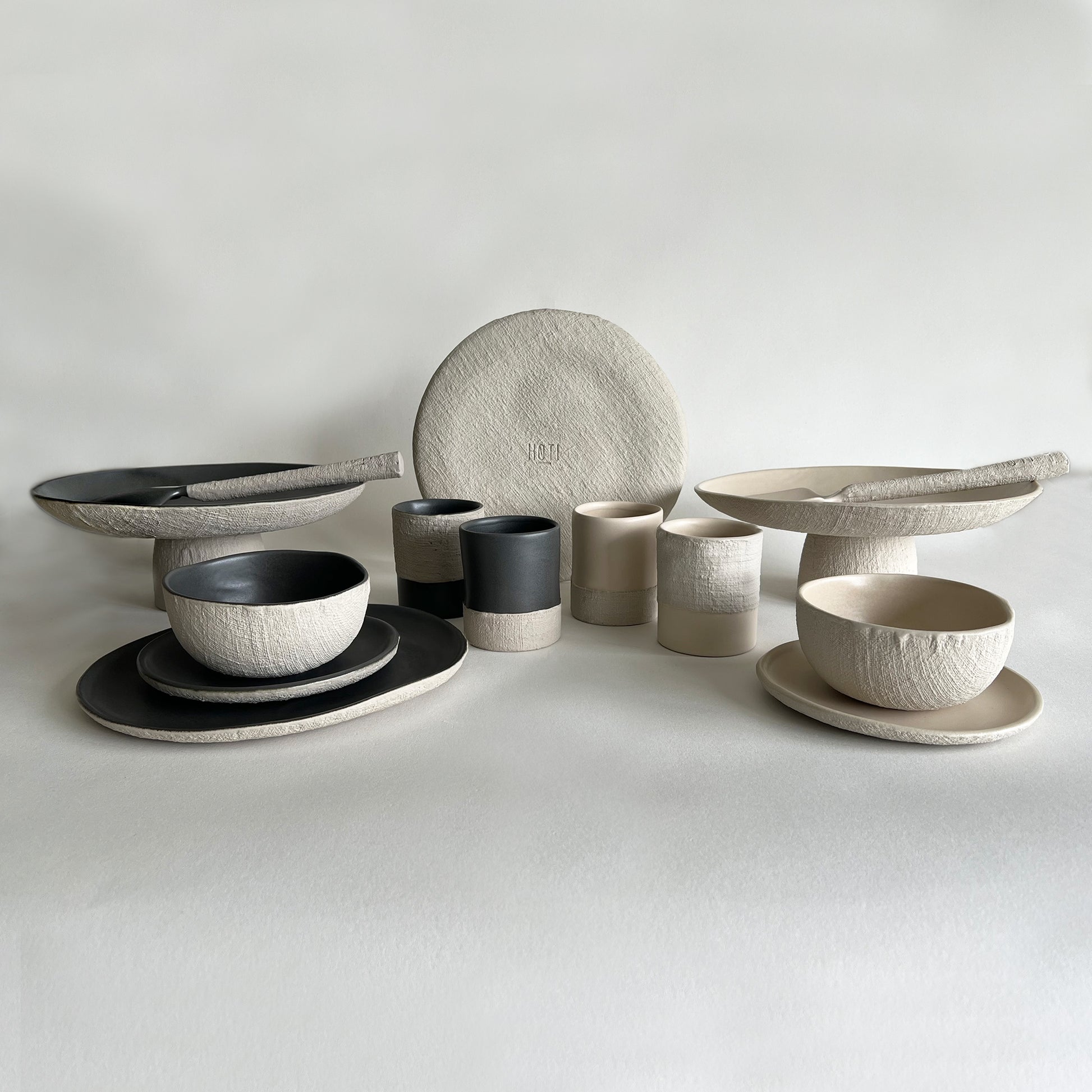 charcoal beige matte textured handmade ceramic stoneware dinnerware, tableware set of plates, bowls, trays, cutlery, cups